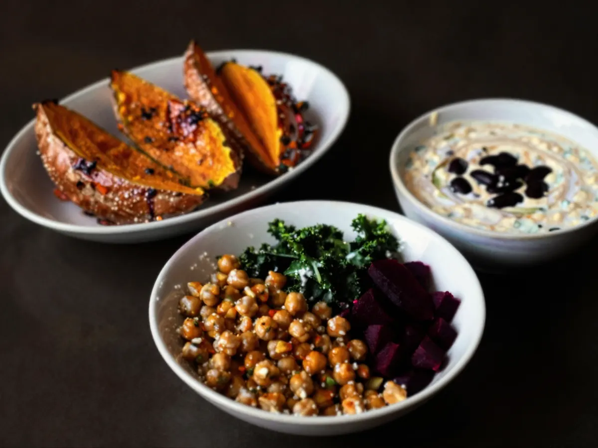 AI-generated photograph: Bright bowls of roasted vegetables and beans